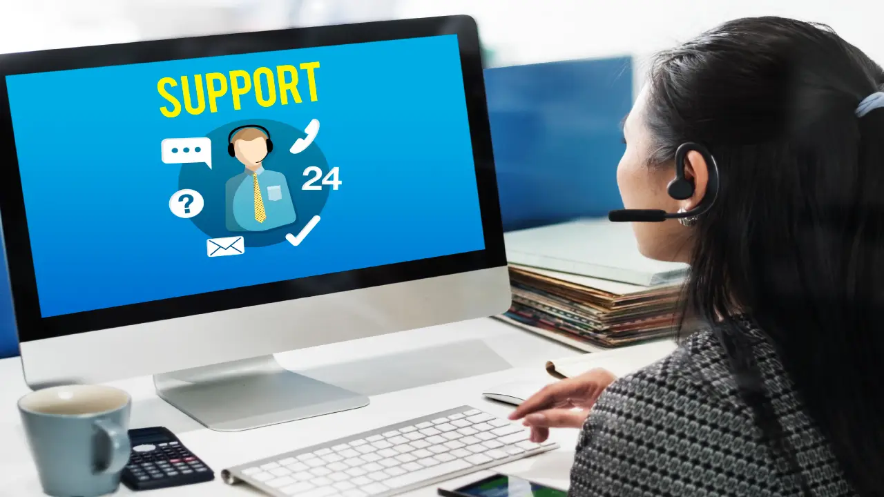 A woman wearing a headset works at a computer displaying a “Support 24” screen with icons for chat, email, and phone, representing customer service assistance.